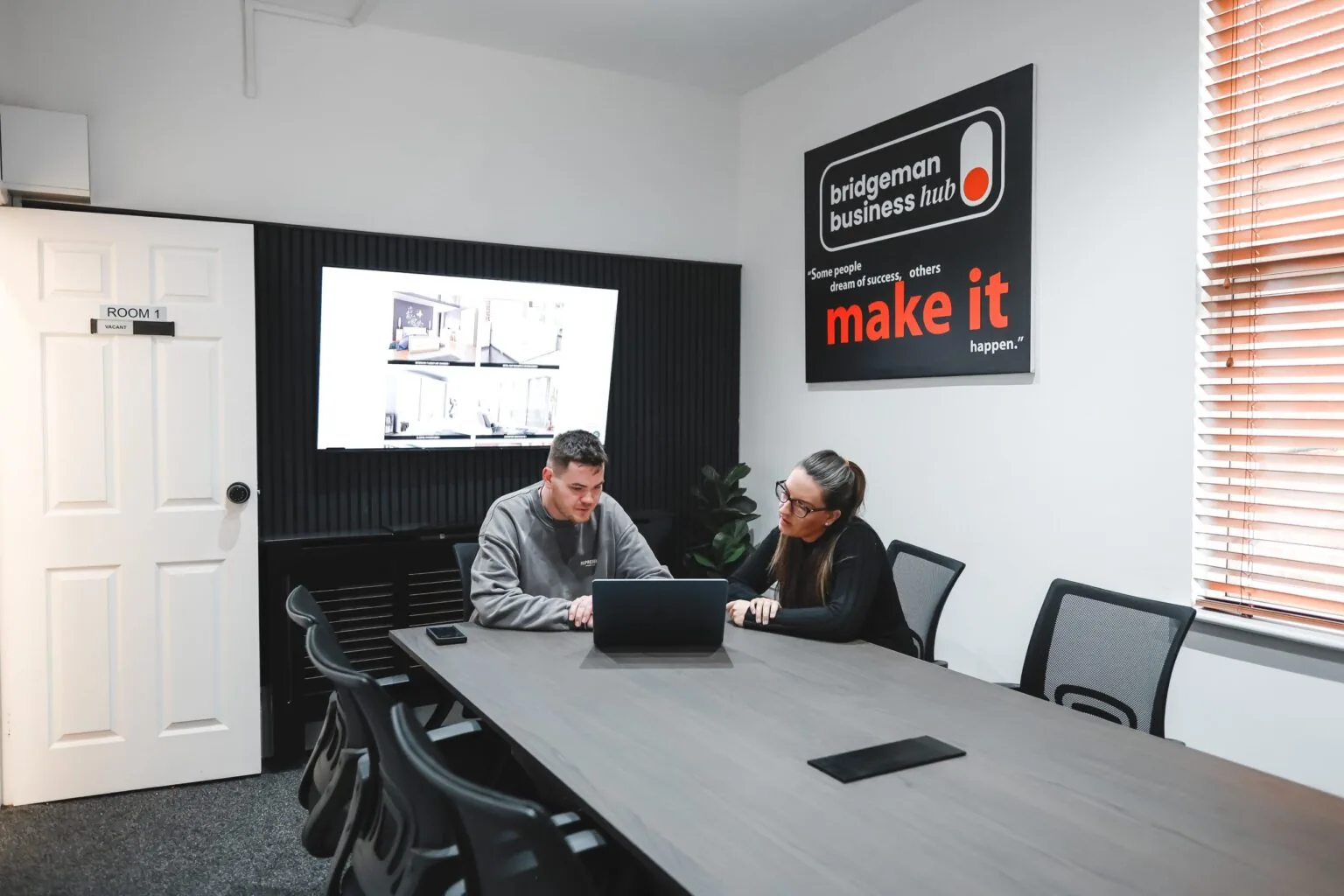 Sam and Trayana working together on a website at the SJH Studio office in Wigan